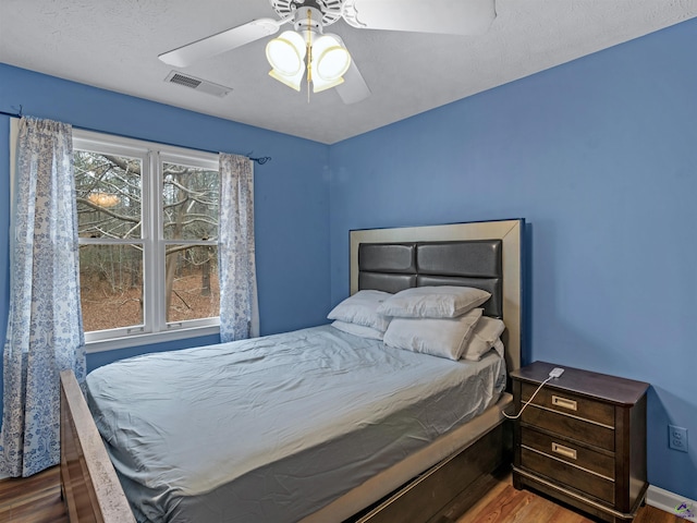 bedroom featuring ceiling fan and wood-type flooring