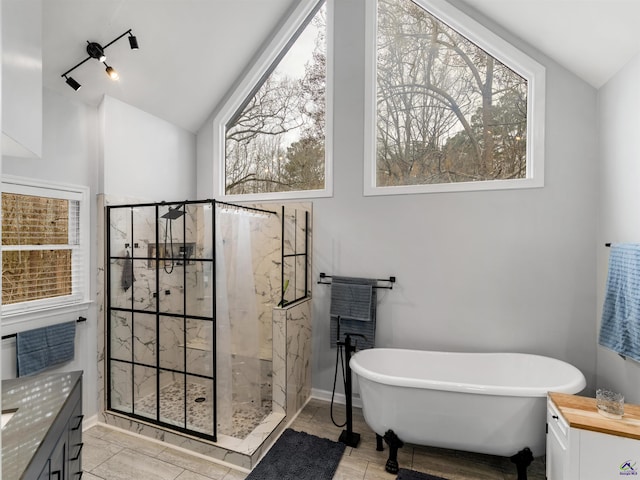 bathroom featuring vaulted ceiling, shower with separate bathtub, a wealth of natural light, and vanity