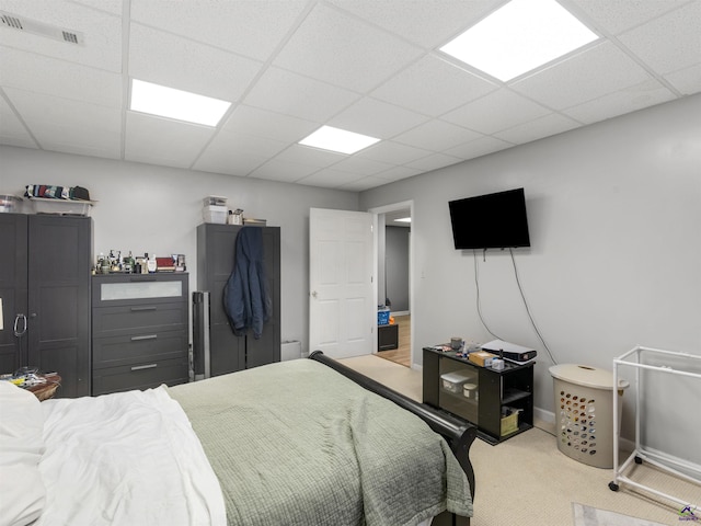 carpeted bedroom featuring a paneled ceiling