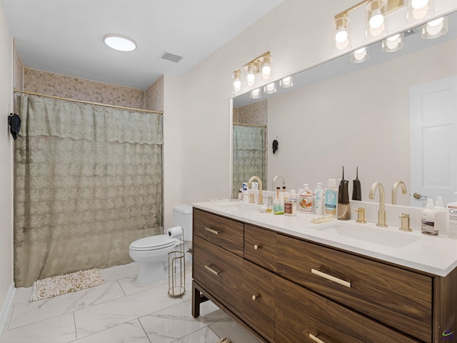 bathroom with vanity, curtained shower, and toilet