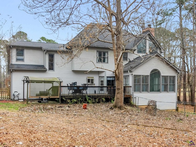 back of house featuring a sunroom and a deck