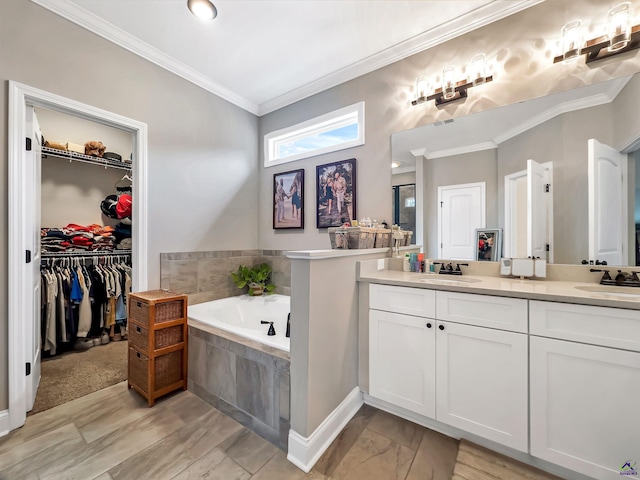 bathroom with crown molding, vanity, and tiled tub