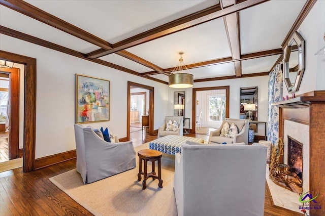 living room featuring coffered ceiling, beam ceiling, ornamental molding, and dark hardwood / wood-style floors