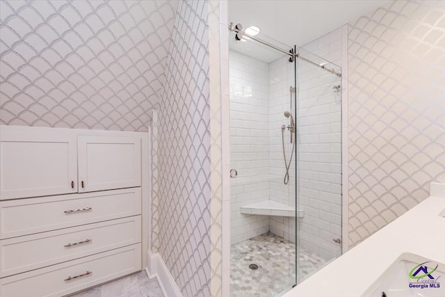 bathroom with a tile shower