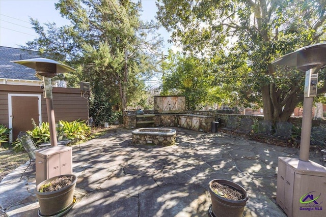 view of patio with a fire pit