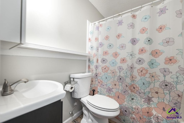 bathroom featuring vanity, toilet, and a shower with shower curtain