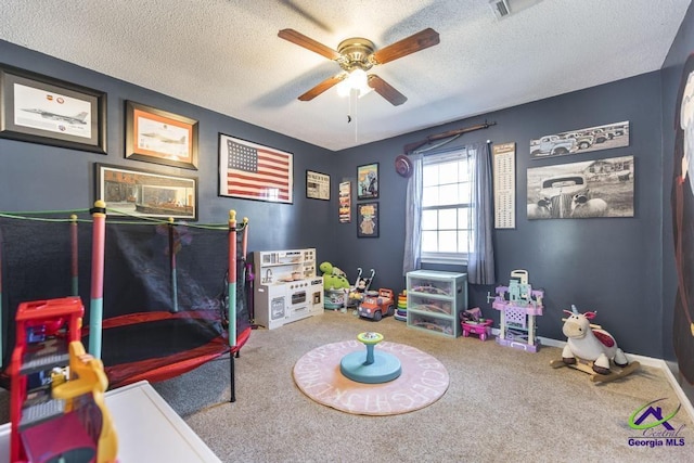 bedroom featuring ceiling fan, carpet, and a textured ceiling