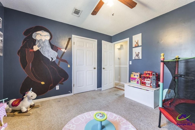 game room with ceiling fan and light carpet