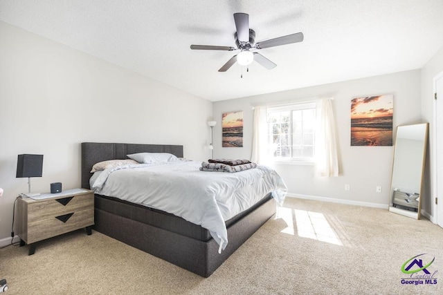 bedroom with ceiling fan and light colored carpet