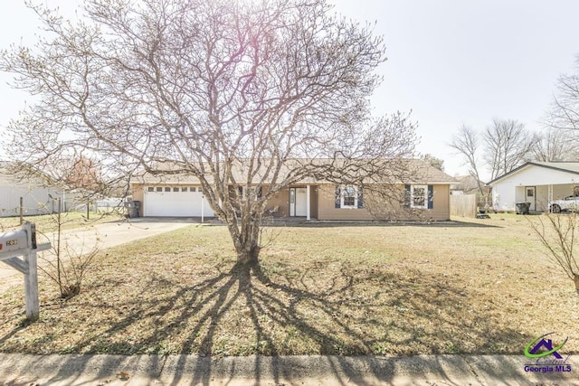 single story home featuring a garage and a front yard