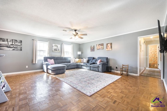 living room featuring crown molding, parquet floors, ceiling fan, and a textured ceiling