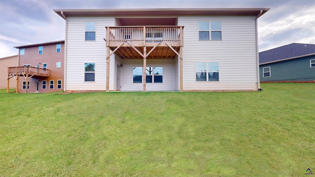 rear view of property with a yard and a balcony