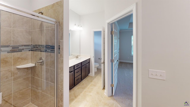 bathroom with vanity, an enclosed shower, toilet, and tile patterned floors