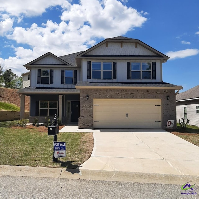 view of front of house featuring a garage and a front yard