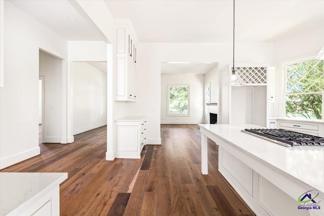 kitchen with decorative backsplash, dark wood-type flooring, pendant lighting, and white cabinets