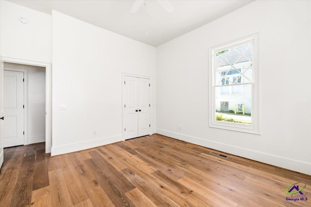 unfurnished room with ceiling fan and wood-type flooring