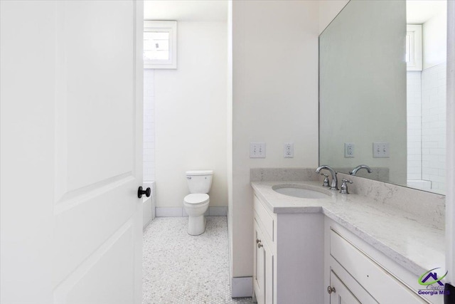 bathroom featuring toilet and vanity