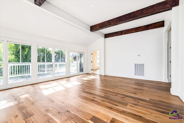 unfurnished living room with hardwood / wood-style floors and lofted ceiling with beams