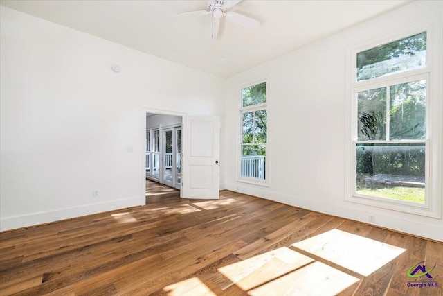 spare room with dark hardwood / wood-style floors and ceiling fan