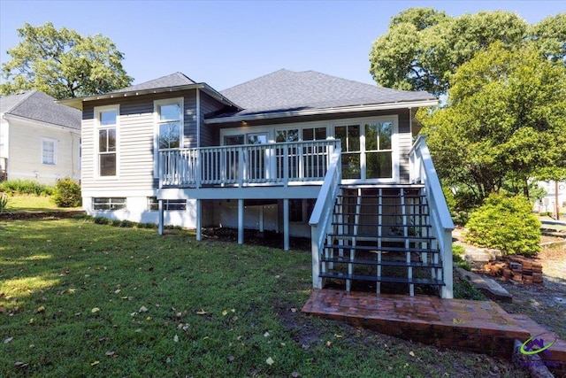 back of house with a deck and a yard