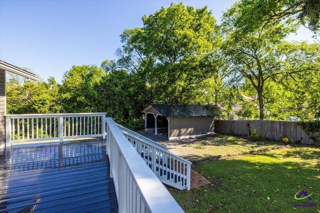 deck featuring a storage unit and a lawn