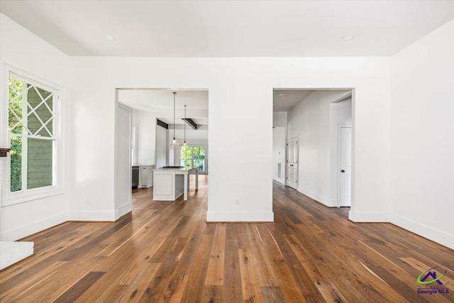 unfurnished living room with dark wood-type flooring