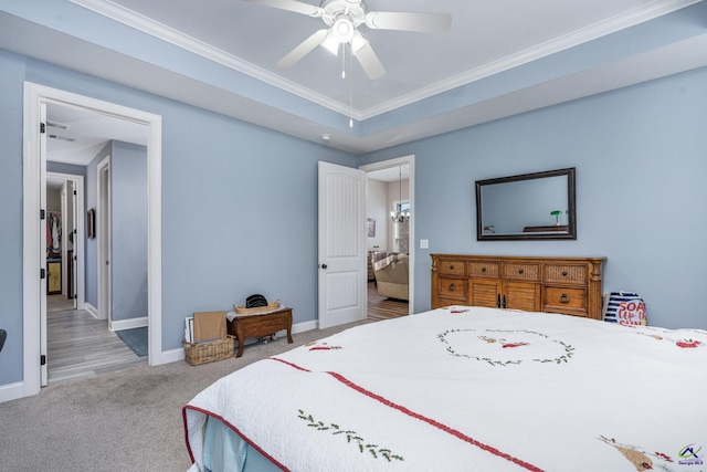 carpeted bedroom with ceiling fan and ornamental molding