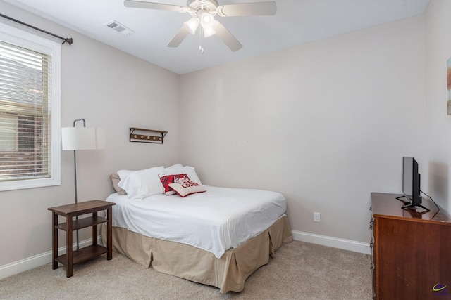 bedroom featuring light carpet and ceiling fan