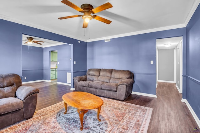 living room with ceiling fan, dark wood-type flooring, and crown molding