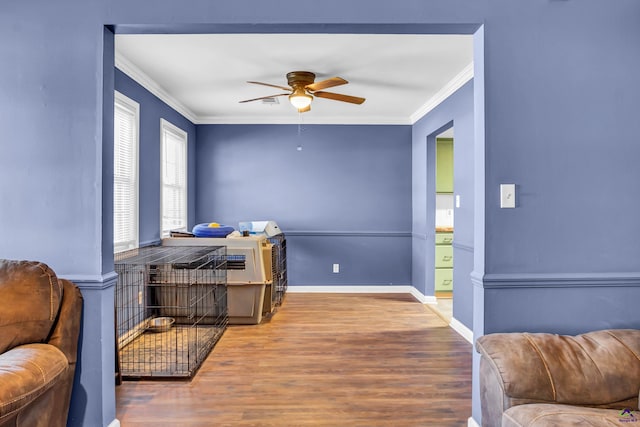 interior space featuring ornamental molding, hardwood / wood-style floors, and ceiling fan