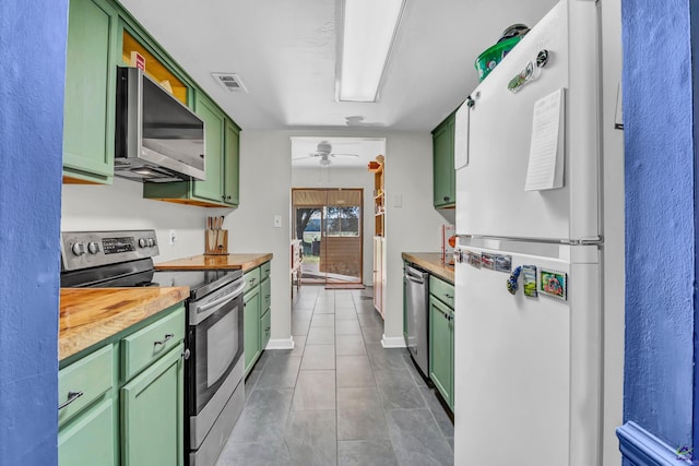 kitchen with green cabinetry, stainless steel appliances, ceiling fan, and wooden counters