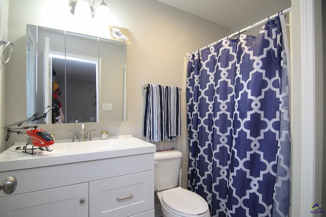 bathroom featuring toilet and vanity