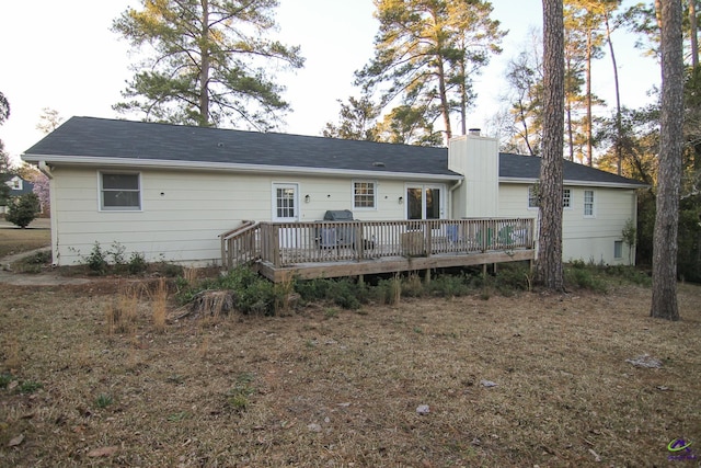 back of house featuring a wooden deck