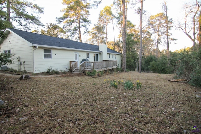 back of house featuring a wooden deck