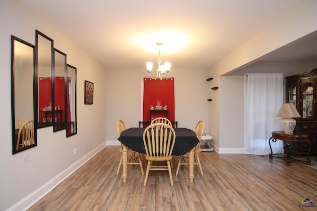 dining room featuring an inviting chandelier and wood-type flooring