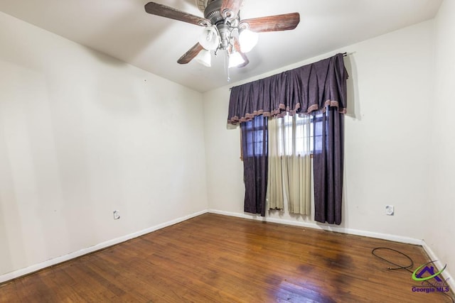 empty room featuring ceiling fan and hardwood / wood-style floors