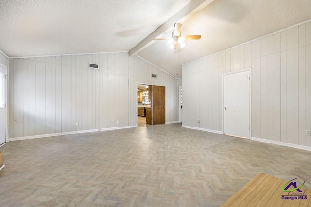 unfurnished living room with a textured ceiling, vaulted ceiling with beams, light parquet flooring, and ceiling fan