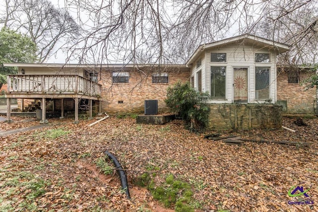 back of property featuring a wooden deck