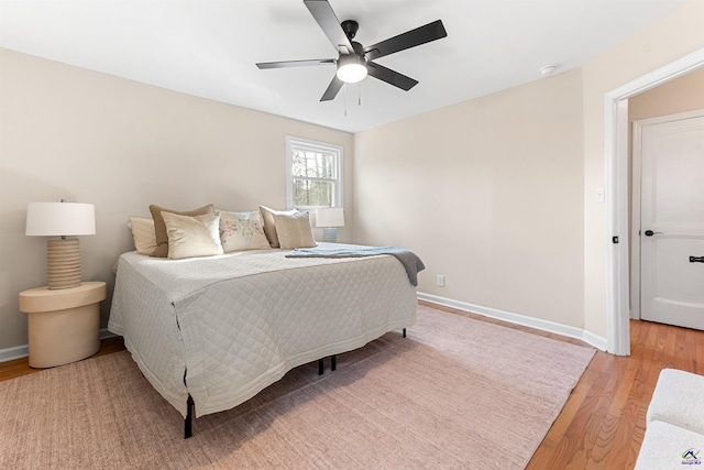 bedroom with ceiling fan and light hardwood / wood-style flooring