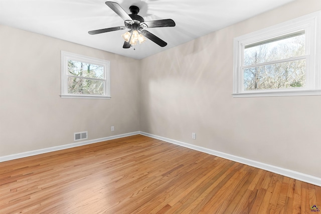 empty room featuring ceiling fan and light hardwood / wood-style floors