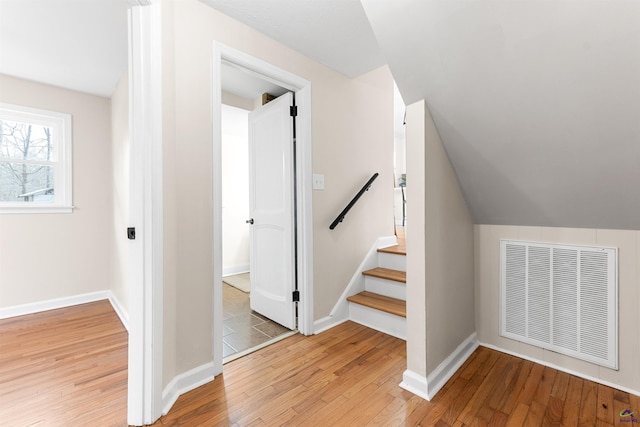 interior space featuring lofted ceiling and wood-type flooring