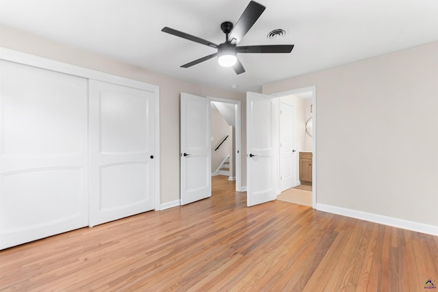 unfurnished bedroom featuring ceiling fan, light hardwood / wood-style floors, and a closet