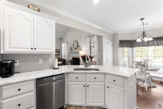 kitchen with dark hardwood / wood-style floors, stainless steel dishwasher, white cabinets, hanging light fixtures, and decorative backsplash