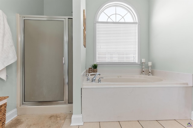 bathroom with plus walk in shower, tile patterned floors, and a healthy amount of sunlight