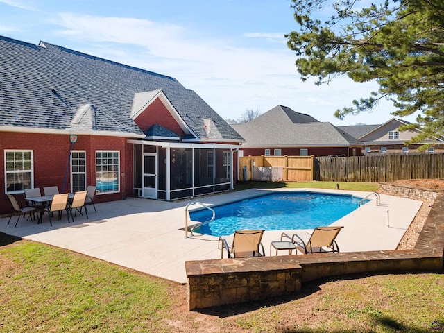 view of swimming pool with a patio and a sunroom