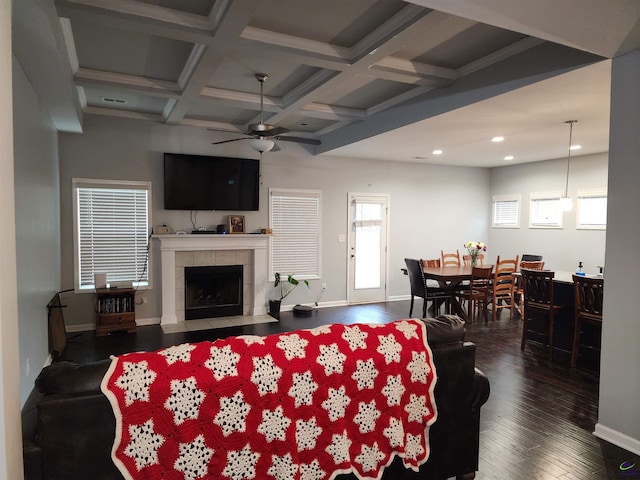 living area with ceiling fan, dark wood-type flooring, a fireplace, coffered ceiling, and baseboards