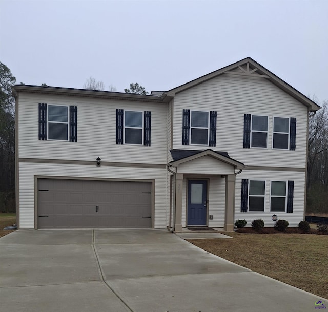 view of front of house with a garage and concrete driveway