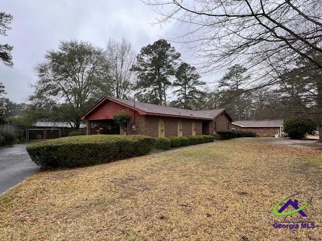 view of home's exterior with driveway and fence