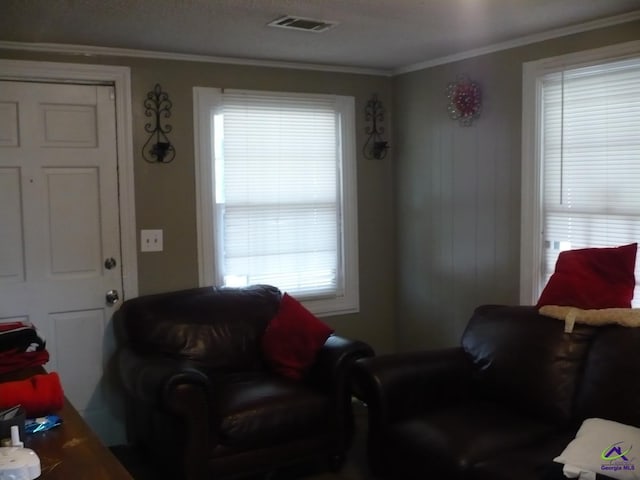 living room with visible vents and crown molding