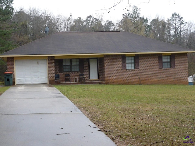 ranch-style home with a front yard, brick siding, driveway, and an attached garage